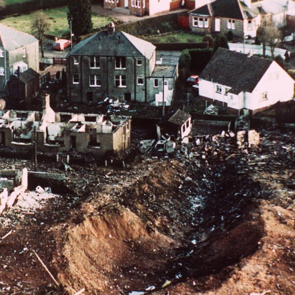 FILE - This December 1988 file photo shows wrecked houses and a deep gash in the ground in the village of Lockerbie, Scotland, that was caused by the crash of Pan Am Flight 103. Families of some of the 270 people who died in the airliner bombing 25 years ago gathered for memorial services Saturday, Dec. 21, 2013, in the United States and Britain, honoring victims of the terror attack that killed dozens of American college students and created instant havoc in the Scottish town where wreckage of the plane rained down. (AP Photo/Martin Cleaver, File)