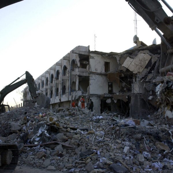 US Army (USA) Soldiers assigned to the 203rd Combat Engineer Battalion, Missouri Army National Guard (ANG) use a tracked excavator to remove tons of rubble and debris as rescue worker search for victims a the United Nations (UN) Office of Humanitarian Coordinator Building in Baghdad, Iraq, after a truck bombing destroyed much of the building during Operation IRAQI FREEDOM.